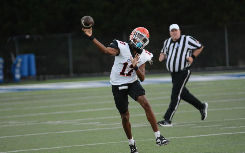 Sophomore quarterback Kurston Curry throws on the run in the 35-10 loss to the Warriors of Oconee County on Aug, 9.