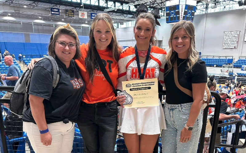 Senior competition cheerleader Bree Dickerson (third one from the left) standa with her coaches after making the All-State team.