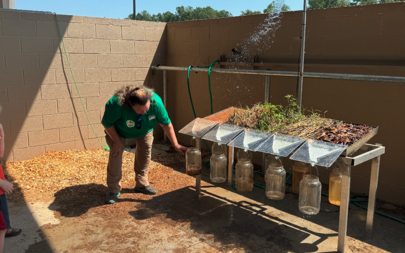 The USDA Natural Resources Conservation Service demonstrated a rainfall simulator display showing how rain can cause a runoff on soil.