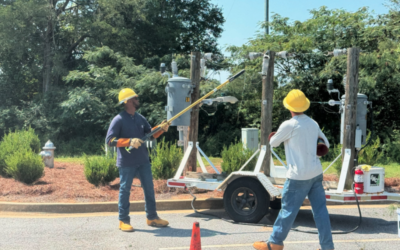 Linemen from Hart EMC demonstrate how electricity works for the children at the 2024 Northeast Georgia Ag Expo.