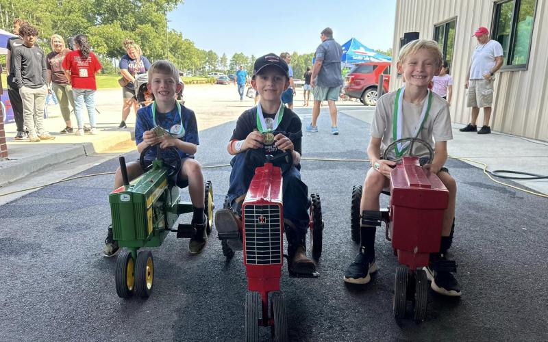 Pictured above (from left to right), are the winners of each age division in the Pedal Tractor Race including Caleb McCollum (7-8), Jordan Flanagan (5-6), and Rhett Simpson (9-10).