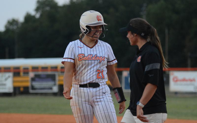 Sophomore pitcher Chesnee Strickland celebrates with assistant coach Meredith Dunn after a base hit on Aug. 29.