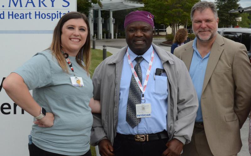 More than 100 healthcare professionals, First Responders and community leaders attended a barbecue sponsored by St. Mary’s Sacred Heart Hospital and Surgical Affiliates Management Group Inc. to celebrate the surgery program’s expansion into elective surgeries. Pictured are (from left) clinic coordinator Ashlee Dove, Dr. Abdul Bangura and David Van Laecke, AMGI vice president of operations. Photo by Charlie Eavenson/Franklin County Citizen