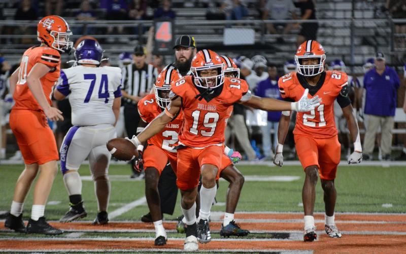 Junior linebacker Elijah Garnett (19) celebrates after picking off Monroe Area’s senior quarterback Forrest Ross’ pass to seal the 28-21 win over the Purple Hurricanes, and put an end to an eight game losing streak against Monroe Area on Sept. 20.