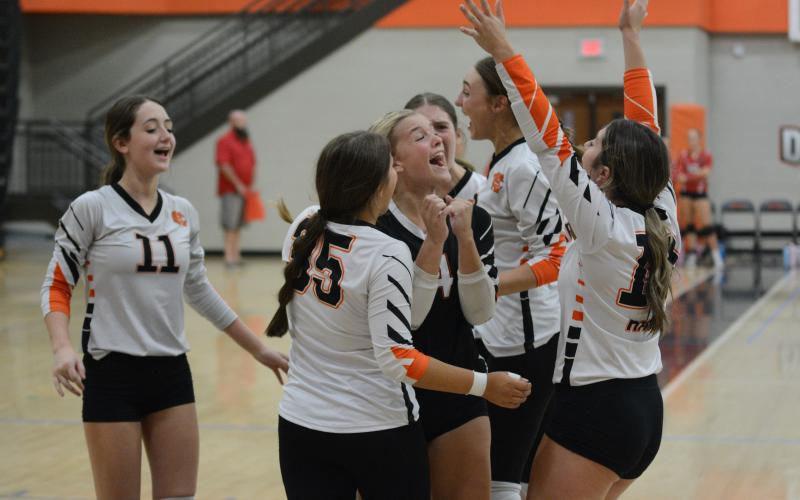The Volley Dogs celebrate after defeating Westside of Anderson, S.C. in three sets: 27-25, 23-25, and 15-12.