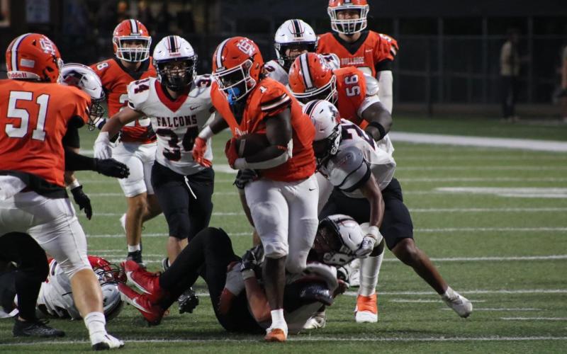 Senior running back Timothy Newton (middle) gets his first carry of the season in his first game back from injury on Sept. 9. Photo by Grayson Williams.