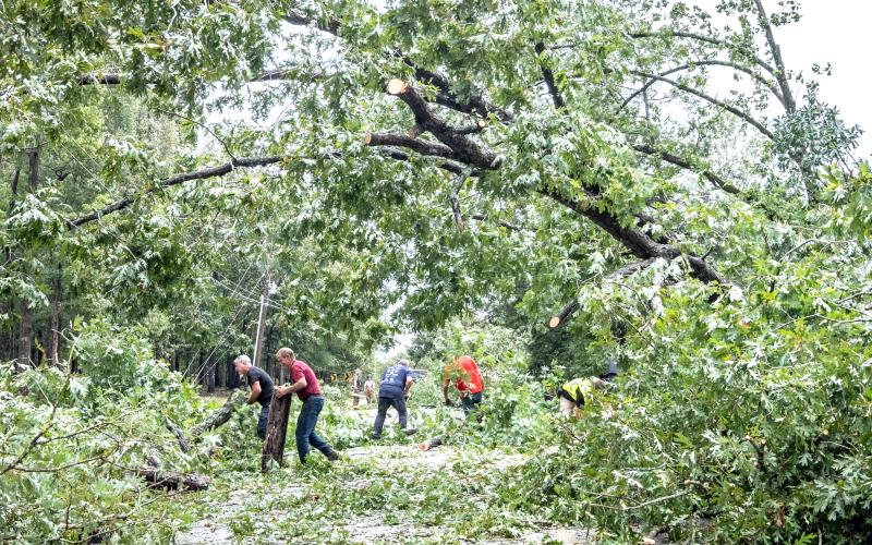 Hart County’s first responders and residents come together to clean up storm debris and downed power lines along Lightwood Rd. Friday following Hurricane Helene. Photo by Bill Powell/The Hartwell Sun