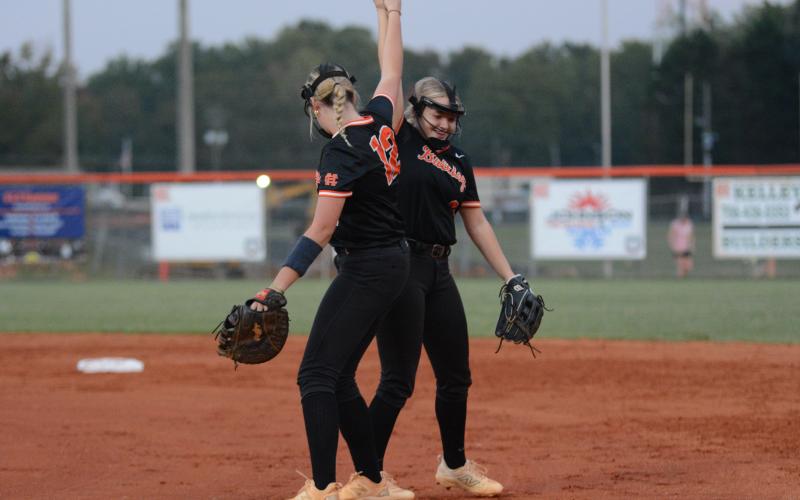 Junior first baseman Kinsley Duncan and sophomore second baseman Carly Dutton celebrates after a 2-0 shutout win over the Lady Tigers of Commerce on Senior Night Sept. 30.