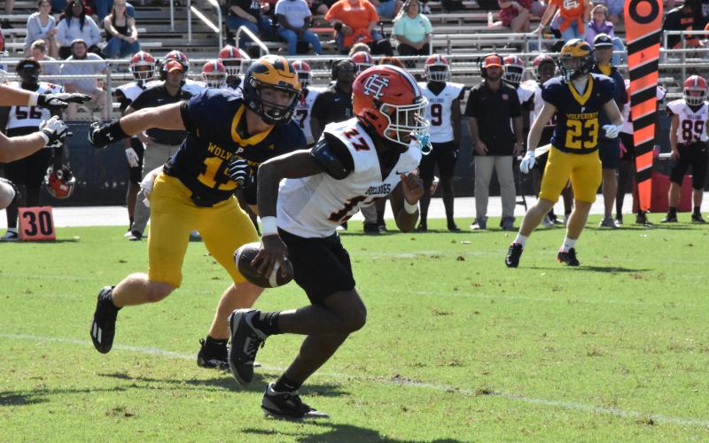 Sophomore quarterback Kurston Curry scrambles out of the pocket in the 43-21 loss to Prince Avenue Christian Sept. 28. Photo by Stuart Steele/The Oconee Enterprise