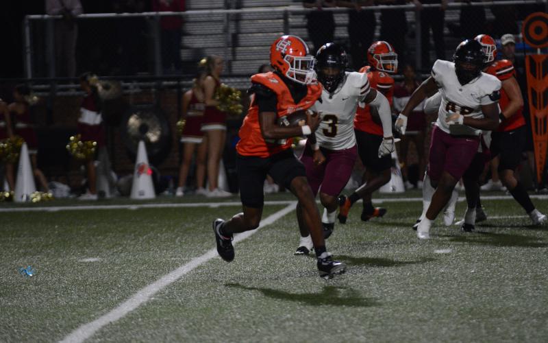 Sophomore quarterback Kurston Curry attempts to evade the pressure from the Lions defense in the 45-0 loss Oct. 4.