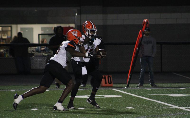 Sophomore quarterback Kurston Curry hands the ball off to sophomore running back Faustino Rangel, who scores three rushing touchdowns in the 40-10 win over the Eagles of East Jackson on Oct. 18. Photo by Cheyenne Tolleson/Jackson Harold TODAY