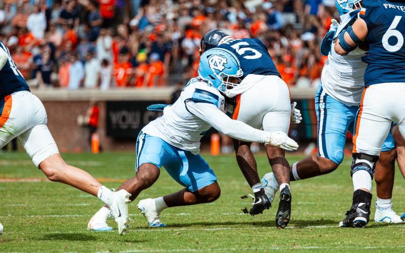 Rucker makes the tackle on the Cavaliers’ running back in the 41-10 win over Virginia. Photo by UNC Athletics.