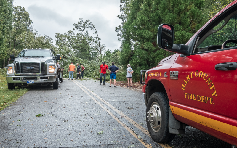 Hart County’s first responders and residents come together to clean up storm debris and downed power lines along Lightwood Rd. Friday following Hurricane Helene. Photo by Bill Powell/The Hartwell Sun