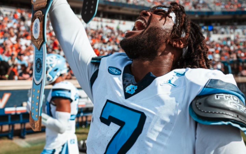 Former Bulldog and current UNC defensive end Kaimon Rucker holds up the UNC WWE turnover belt after collecting an interception in the Tar Heels 41-10 win in Charlottesville against the Cavaliers of Virginia. Photo by UNC Athletics.