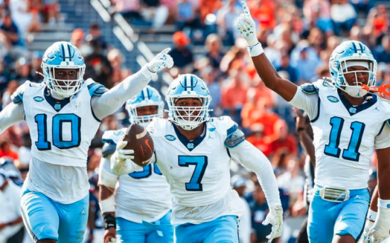 Kaimon Rucker celebrates with teammates after capturing his first career interception. Photo by UNC Athletics.