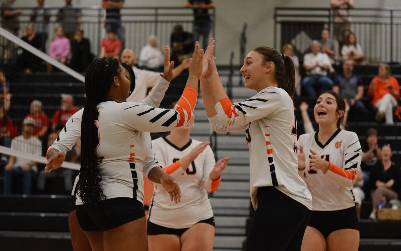 The Volley Dogs celebrate after the 3-1 win over Stephens County in the first round of the Region Tournament Oct. 10.
