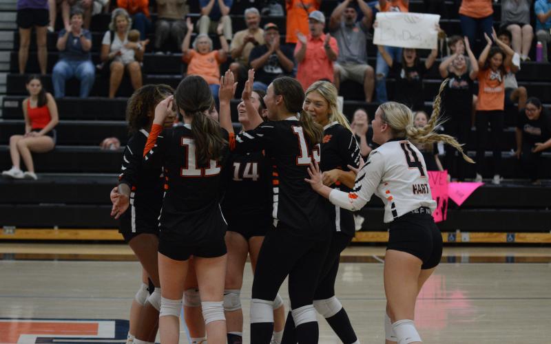 The Volley Dogs celebrate after a 2-0 win (25-21 and 25-19) against Prince Avenue Christian on Oct. 8 to secure a home game in the first round of the region tournament that begins on Oct. 10.