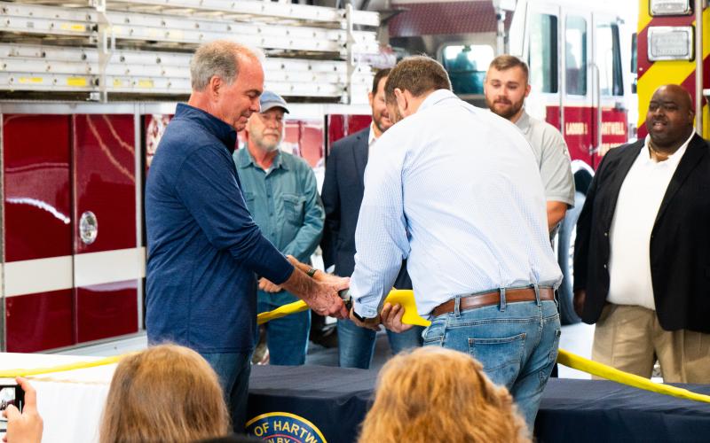 Former Hartwell Fire Chief Terry Vickery and Mayor Brandon Johnson performing the uncoupling ceremony.