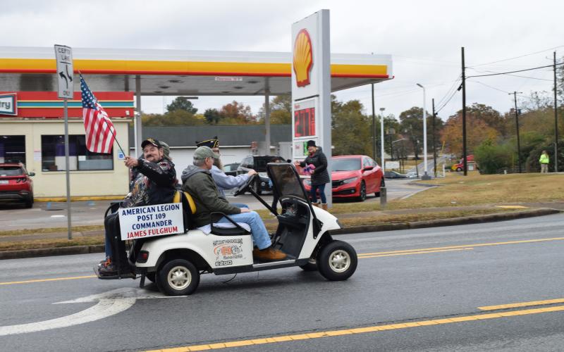 American Legion Post 109 Commander James Fulghum waves the flag during the 2023 Hartwell Veterans Day Parade.