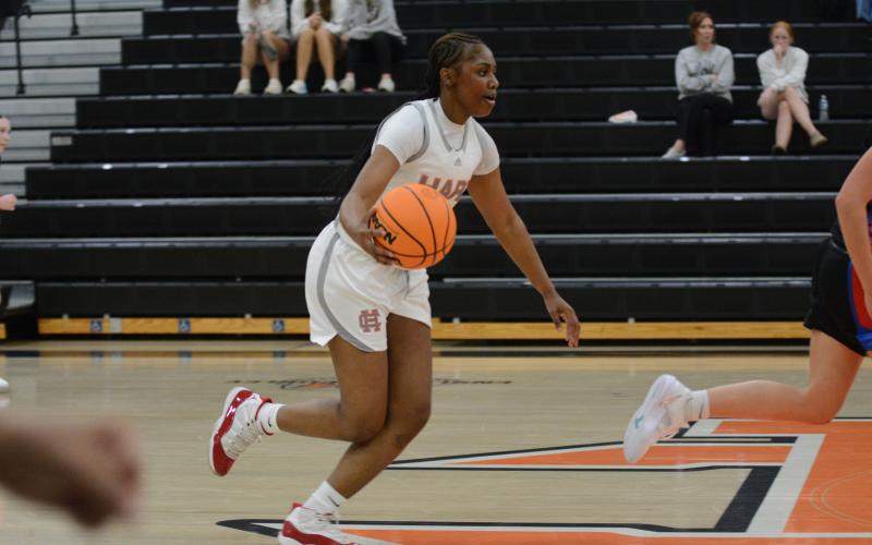 Junior forward Kiasia Montgomery dribbles the ball up the court in the 60-29 win over Oglethorpe County on Nov. 7.