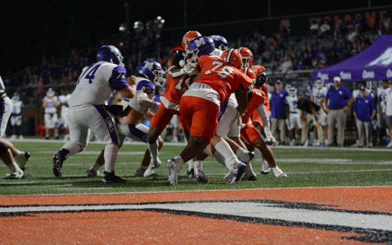 Junior defensive tackle Nicholas Carter (78) sacks the quarterback in the 28-21 win over Monroe Area.