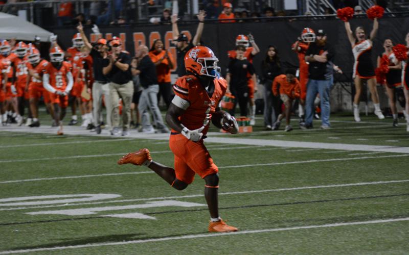Senior running back Timothy Newton rushes for 77 yards and two touchdowns in the 29-9 win over rival Franklin County to clinch the Dogs spot in the state playoffs.