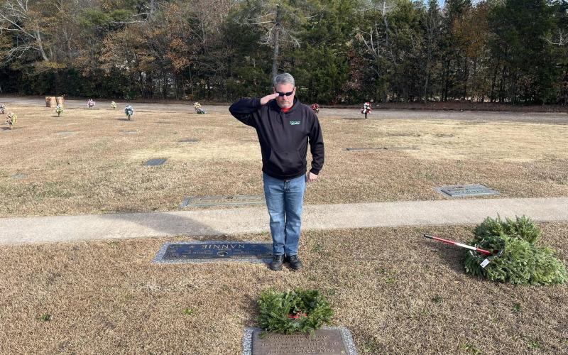 Hartwell volunteer Brian Adams salutes a wreath laid in Nancy Hart Cemetery Dec. 14 during the Wreaths Across America event.