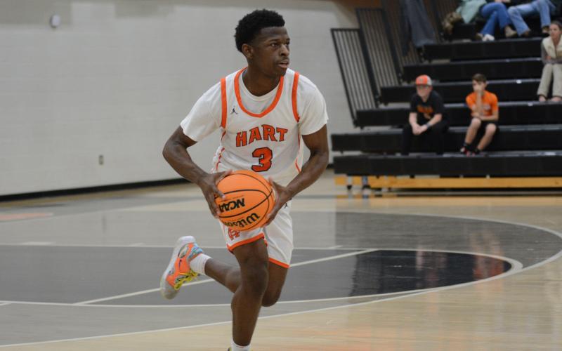 Senior guard Andrew Maxwell looks to pass the ball in the 67-36 win over Athens Academy on Dec. 10.