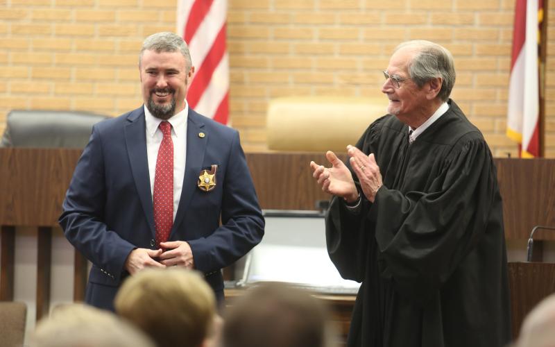 Northern Judicial Circuit Superior Court Judge Chris Phelps (right) claps for Hart County Sheriff Chris Carroll (left) after swearing him into office Dec. 30 inside the Hart County Courthouse.