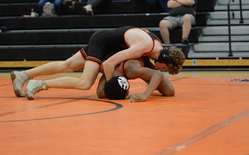 Senior Ethan Stovall pins his opponent to help the Mat Dogs rally back in the 48-34 win over Harlem on Nov. 20.
