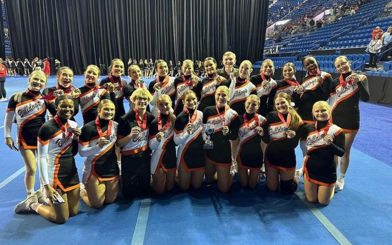 The Hart County High School sideline cheer squad flashes their medals and trophy after claiming state runner-ups at the GHSA gameday competition in Columbus, Ga. on Dec. 4.