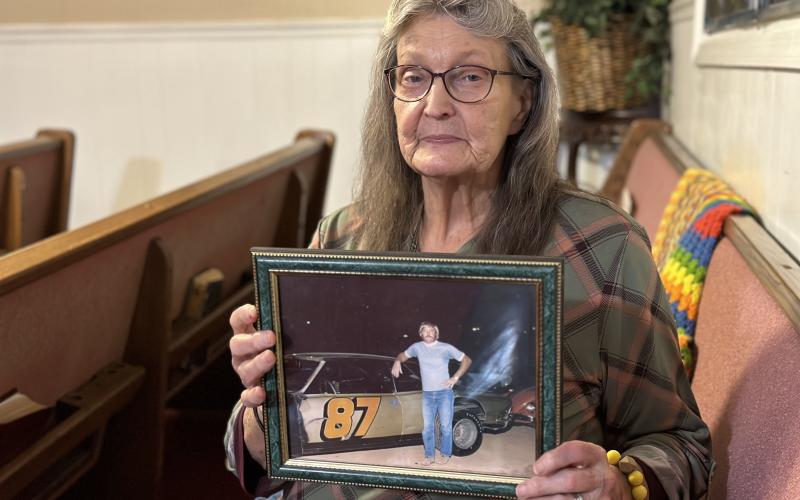 Janice Loggins, one of Frankie Carnes’s sisters, holding a photo of him from around the time he disappeared in the 1970s.