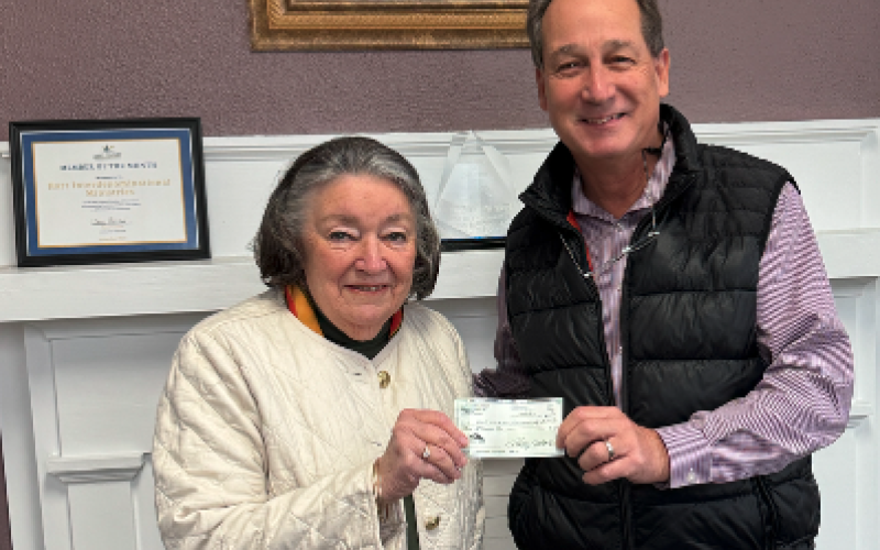 Christina Silpe (left) from Hart Interdenominational Ministries (HIM) receives a $2000 check from Lowell Macher, President of the Hart County Property Owners Association during their Holiday Harvest Fundraiser Nov. 23.