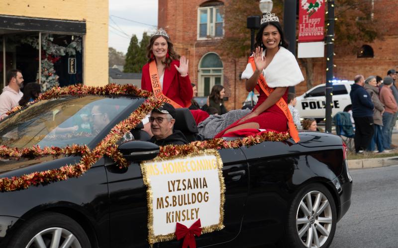 Hart County High School students Kinsley Duncan (left) and Lyzsania Badillo ride in the Christmas Parade as Ms. Bulldog and Ms. Homecoming respectively.
