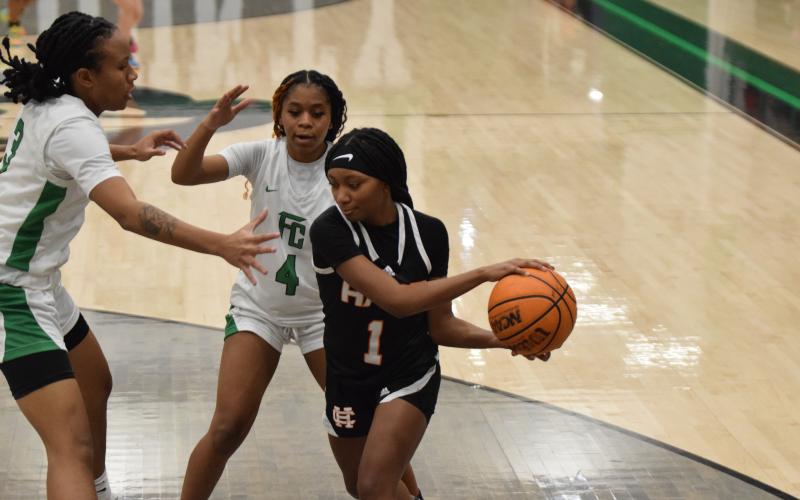 Sophomore guard Jaycee Wiley drives into the paint as she is guarded closely by a pair of Lady Lions defenders. Photo by Shane Scoggins/Franklin County Citizen Leader.