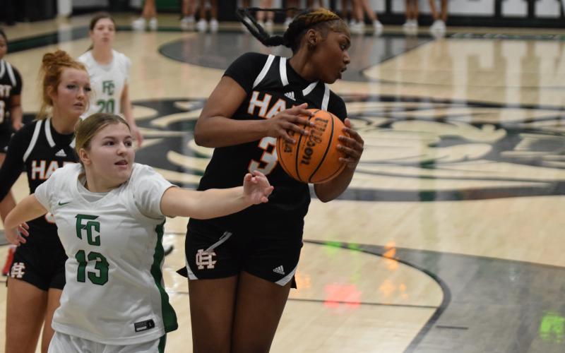 Junior forward Kiasia Montgomery reels in one of her eight rebounds in the 68-51 loss to Franklin County on Jan. 14 in the Lion’s Den. Photo by Shane Scoggins/Franklin County Citizen Leader.