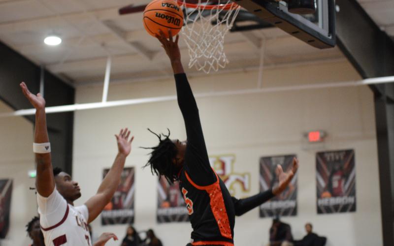 Junior forward Ramarcus Simpson lays it in for the score in the 64-60 loss to Hebron Christian on Jan. 28.