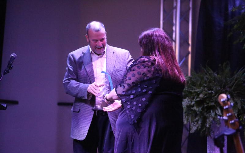 Dwayne Dye, former director of economic development for the Hart County Industrial Building Authority, accepts the Jack Edmunds Lifetime Achievement Award from Hart County Chamber of Commerce Executive Director Amanda Brown during the chamber’s annual awards banquet Feb. 21 at The Station of Hartwell.