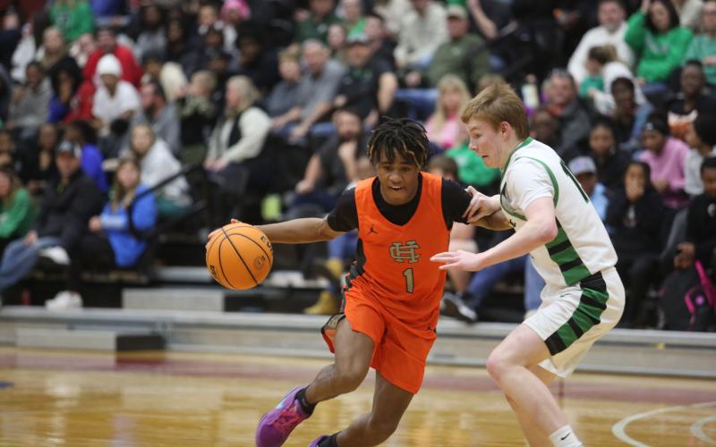Sophomore guard Kurston Curry tries to drive against a Lion in the 79-63 loss to Franklin.