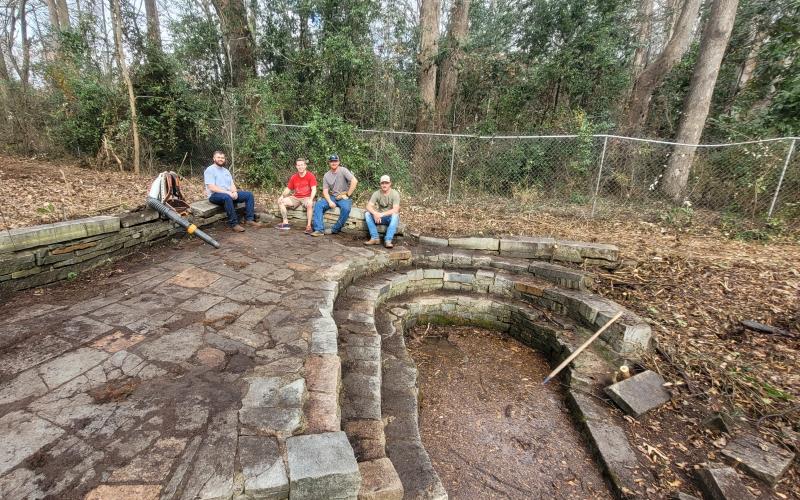 Members of First Methodist Church, including Zach Adams, Sam Stewart, Luke Adams and Zach Mitchell, recently helped clean up the outside area of the center.