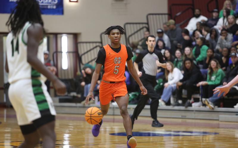 Junior forward Ramarcus Simpson brings the ball up the court in the 79-63 loss to Franklin.