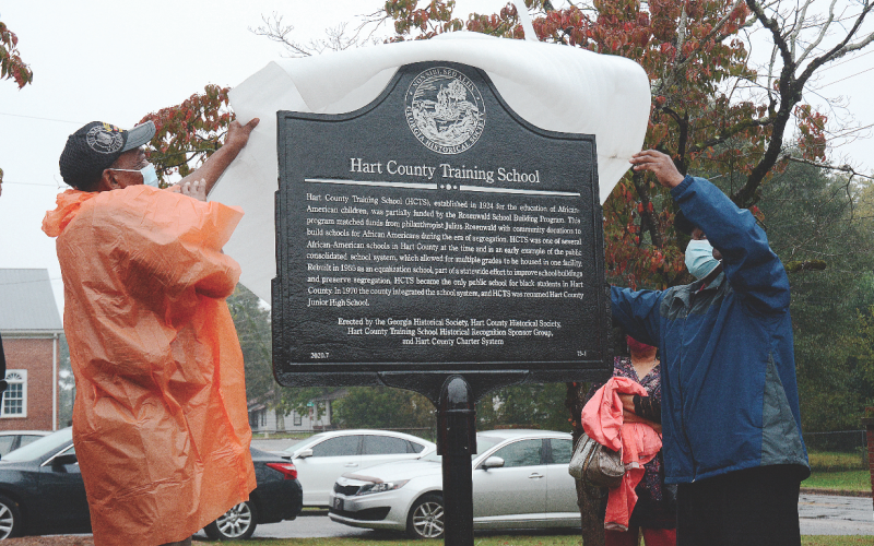Thomas Morrison, left, and Michael Partlow, right, unveil the new historical marker from the Georgia Historical Society at the former Hart County Training School on Richardson Street on Oct. 10, 2020. Photo by former editor/publisher Michael Hall.