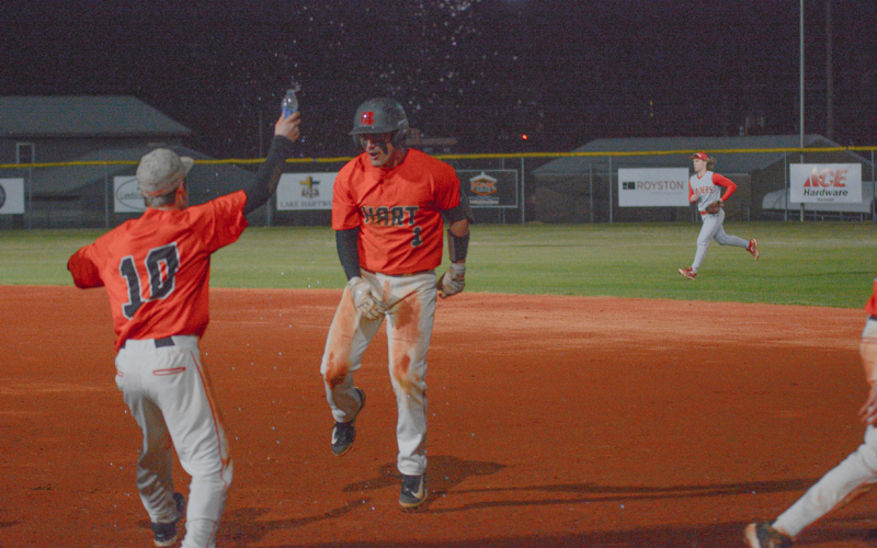 Junior outfielder Boston Graham (right) celebrates with teammates after walking it off against the Red Raiders of Madison County in the 2-1 win on Feb. 24 at Saye Field.