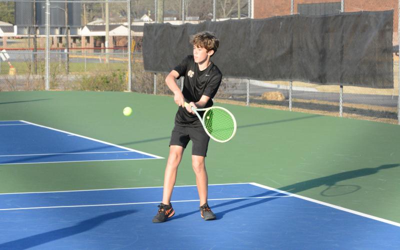 Caleb Carter returns the serve as Carter and Hudson Wise claimed the win at No. 2 doubles to help caputere a 4-1 win over the Eagles of East Jackson on March 13. (Photo/Benjamin London)