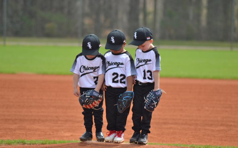 Hart County Little League held its annual Opening Day Saturday, March 15 at the Hart County Recreation Department. The morning include the parade of teams, Hart County High School softball player Kinsley Duncan throwing the first pitch and a day full of first games. Left, (L-R) Reeves Parker, Zachary Wood and Charlie Ray all look for a spot on the pitcher’s mound during a Chicago White Sox game. (Photo/Kenyon Harris)