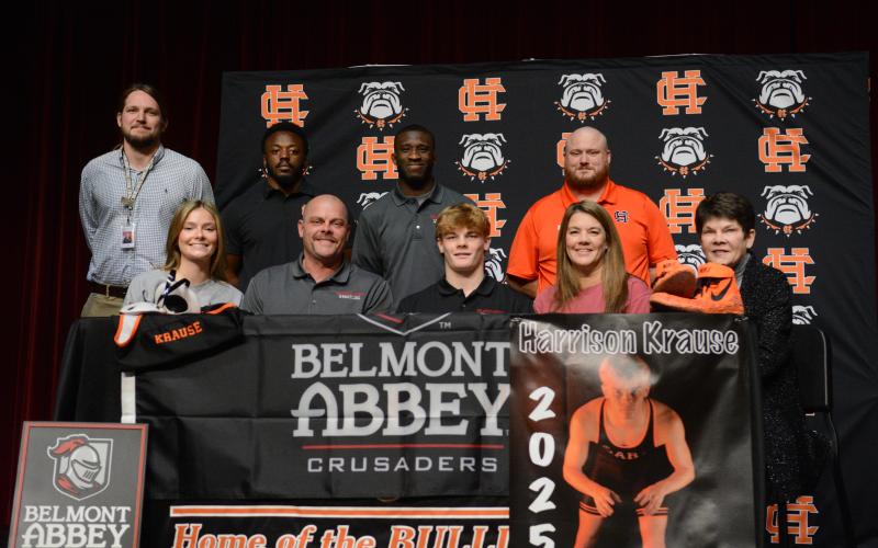 Harrison Krause (middle on first row) surrounded by family and coaches as he signs with Belmont Abbey College to continue his academic and wrestling career.