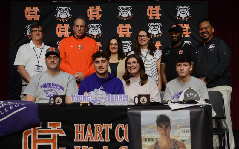 Nate Harris (second from left on first row) surrounded by family and coaches as he signs with Young Harris College to continue his academic, cross country and track career.