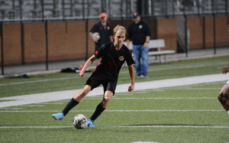 Junior midfielder Will Bell dribbles down the sideline in the 2-1 win over Monsignor Donovan on March 14. (Photo/Benjamin London)