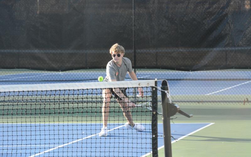 Senior Ayden Mercer returns the serve in a match earlier in the season, as he helped propel Hart County to a 3-1 win over East Jackson with a 7-5, 6-2 win at No. 1 doubles in the first round of the region tournament on April 15. (Photo/Benjamin London)