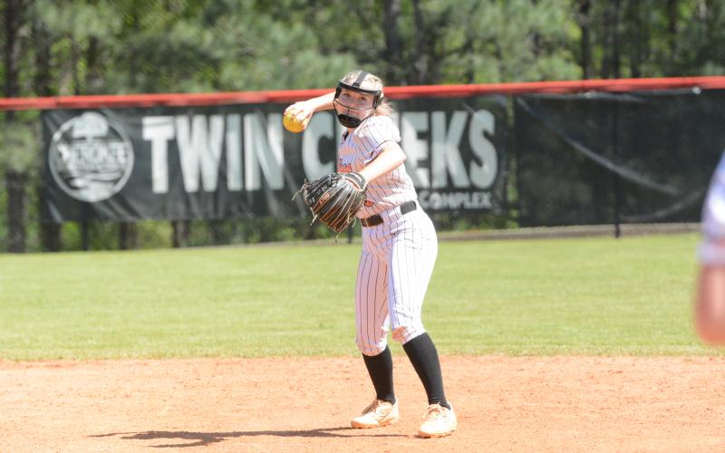 Sophomore infielder Carly Dutton throws to first for the out in the 12-8 win over Cherokee. (Photo/Benjamin London)